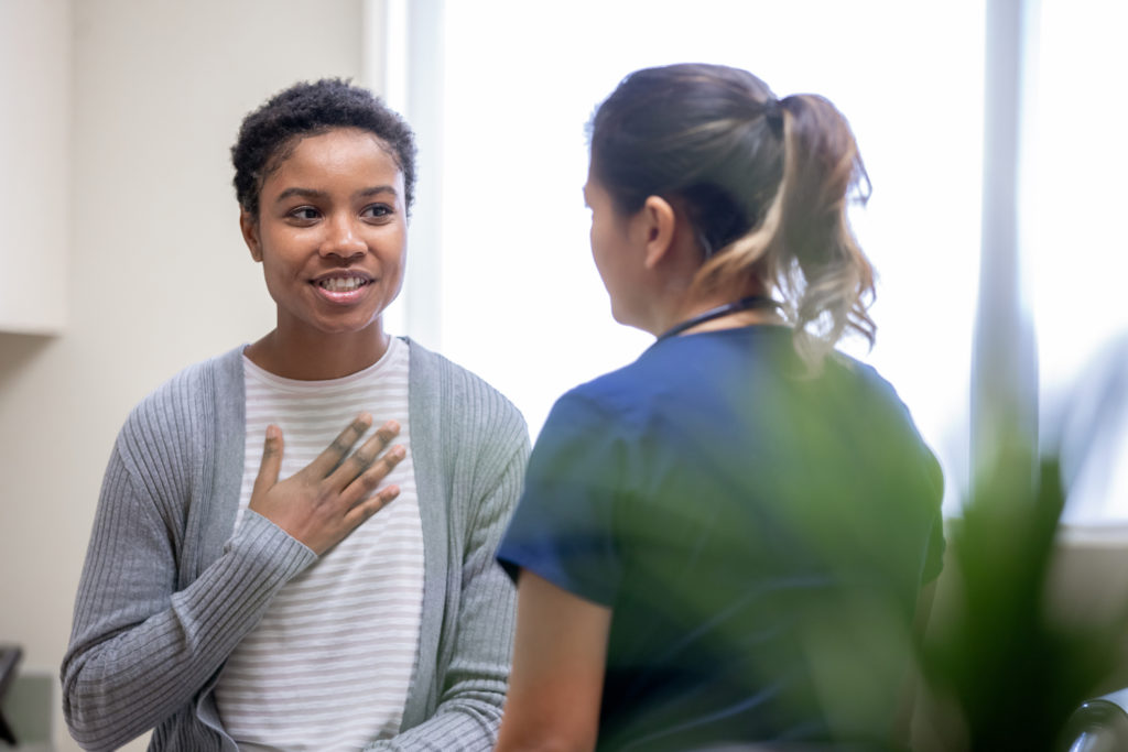 Adolescent speaking with medical professional.