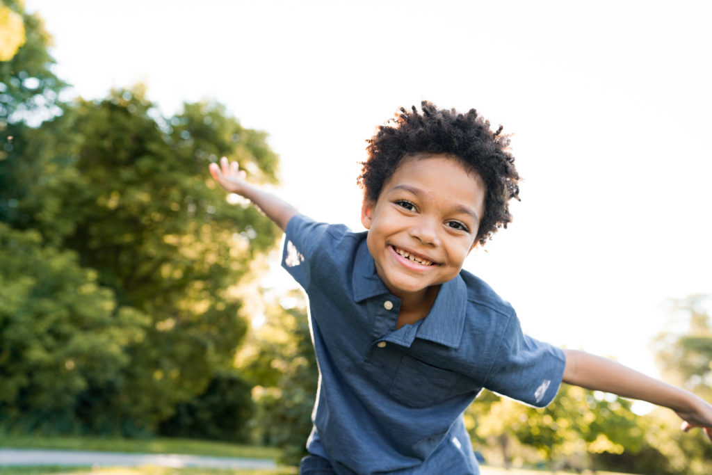 Kid smiling outdoors