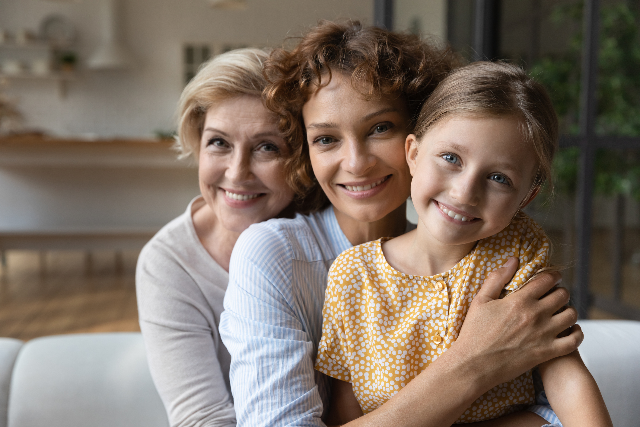 Intergenerational family of three women on sofa