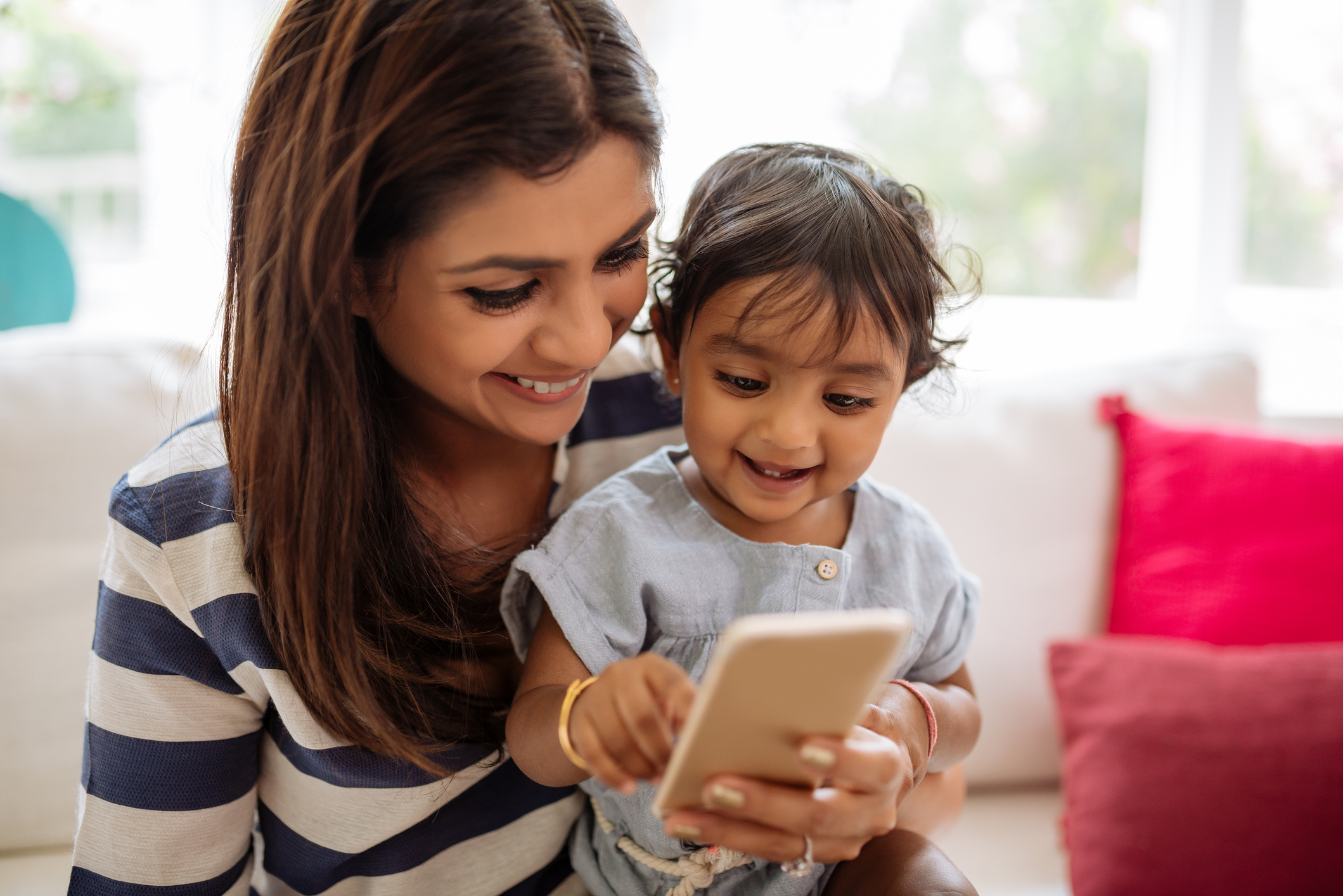 Mother with toddler on smartphone